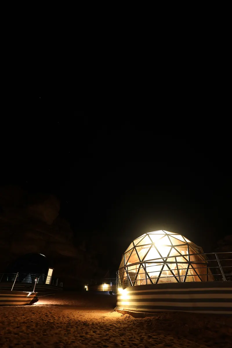 Illustrative: a lit geodesic dome at night in Wadi Rum, Jordan
