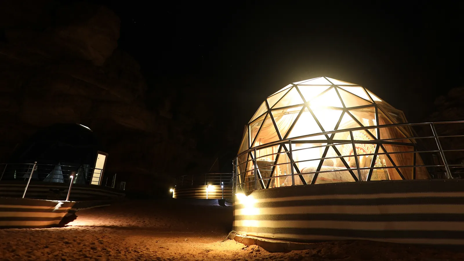 Illustrative: a lit geodesic dome at night in Wadi Rum, Jordan