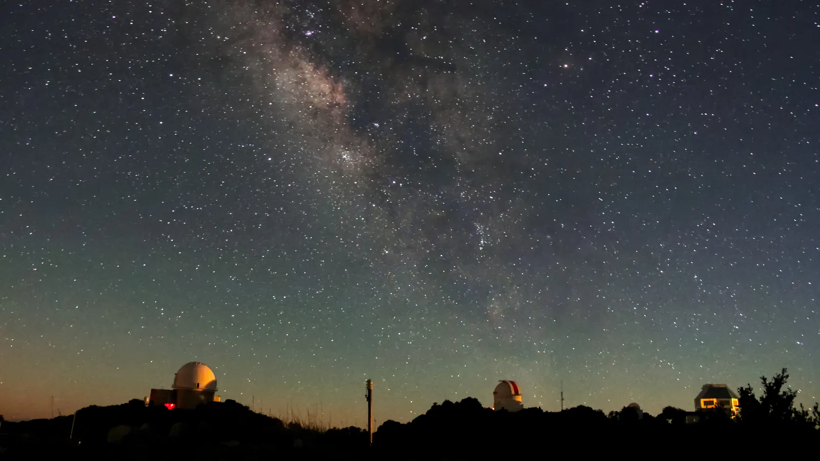 The Milky Way over observatory domes at Kitt Peak, Arizona