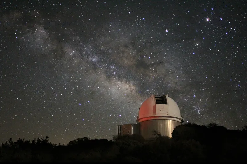 An observatory telescope dome under the Milky Way at Kitt Peak, Arizona